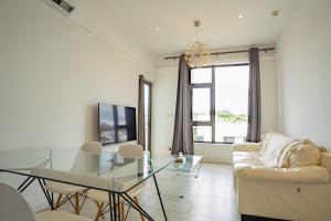 a living room with a glass table and a couch at Ebene City Centre - 2 Bedroom Apartment in Ebene