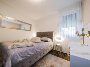a bedroom with a bed and a mirror on the wall at Deluxe Apartment Bono in Sinj