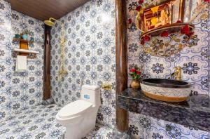 a bathroom with a toilet and a sink at Wooden chill house in Hoi An +35 photos