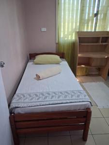 a small bed in a room with a window at DELAILOA ADVENTURES Homestay with Tom in Nadi