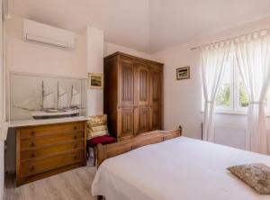 a bedroom with a bed and a wooden dresser at Villa Pax in Studenci +14 photos