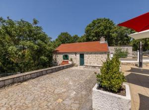 a stone building with a red roof at Villa Pax in Studenci