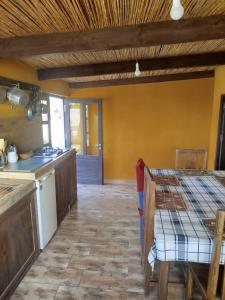 a kitchen with a table and a counter top at Castello in Anakao