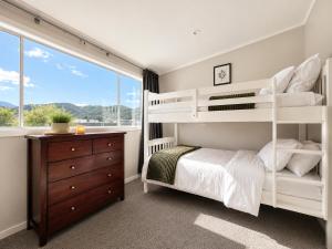 a bedroom with bunk beds and a window at The Nelson Lookout - Mountain Views & City Centre Living in Nelson