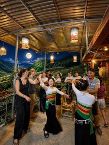 a group of people dancing in front of a crowd at OH Pu Luong Homestay in Làng Bang