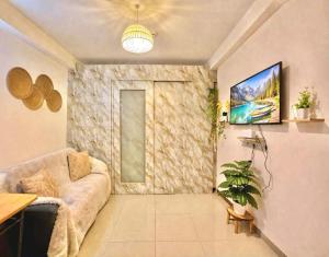 a living room with a couch and a stone wall at Shore Residences 1 tower D in Manila