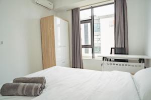 a bedroom with a white bed and a window at Ebene City Centre - 2 Bedroom Apartment in Ebene
