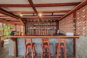 a bar with two stools at a counter in a room at Jaguar Beachfront Ecohotel & Spa in Santa Marta +37 photos
