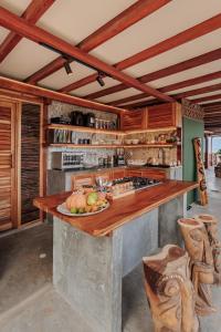 a kitchen with a counter with a plate of fruit on it at Jaguar Beachfront Ecohotel & Spa in Santa Marta