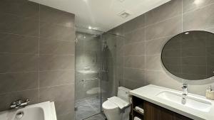a bathroom with a shower and a sink and a toilet at The Dome Grand in Ninh Lão
