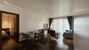 a living room with a table and chairs and a couch at The Dome Grand in Ninh Lão