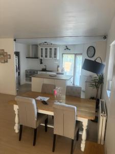 a kitchen and dining room with a wooden table and chairs at Maison familiale in La Souterraine