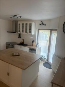 a kitchen with white cabinets and a counter top at Maison familiale in La Souterraine