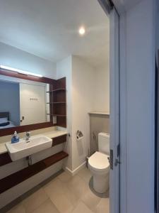 a bathroom with a sink and a toilet at Ebene City Centre - 2 Bedroom Apartment in Ebene