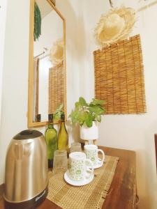 a table with a coffee pot and a mirror at Amwani Garden Pool & Kubo in Puerto Princesa City