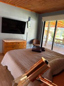 a bedroom with a large bed and a chair at Habitación Suite in Chimbarongo