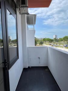a balcony with a window and a view of a street at The F House in Danang