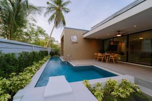 a swimming pool in the backyard of a house at Radarin Villa in Ban Khao Kloi