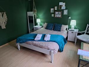 a green bedroom with a bed and a green wall at Muddy Puddles Farm in Kovachevets
