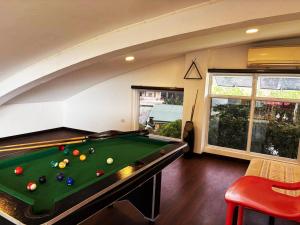 a pool table in a room with an attic at The Transient Villa Hotel and Suites in Cordova