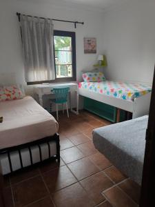 a room with two beds and a desk and a window at LANZATE! in Tinajo +113 photos
