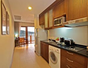 a kitchen with a sink and a dishwasher at The Sea View Residence in Ban Bang Bao