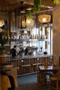 a restaurant with a bar with tables and chairs at Happiness Hostel El Nido in El Nido