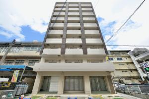 a tall building on a city street at Hotel HIRAKU RYUKYU -STYLE- in Naha