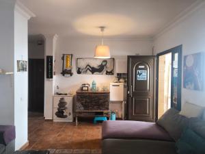 a living room with a couch and a refrigerator at LANZATE! in Tinajo