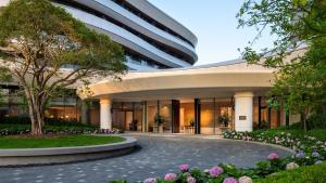 a rendering of a building with a tree and flowers at Kimpton Nine Trees Shanghai by IHG in Shanghai