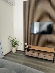 a living room with a flat screen tv on a wall at La Cazatila in Petite Île