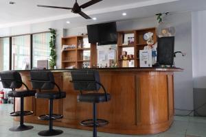 a bar with black stools in a restaurant at Emerald hotel in Jomtien Beach