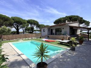 a villa with a swimming pool and a house at Villa Pins by Costabravaway in Llagostera