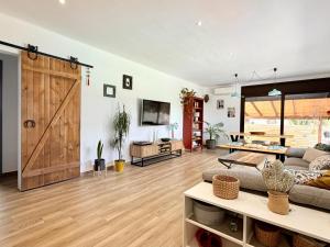 a living room with a sliding barn door at Villa Pins by Costabravaway in Llagostera