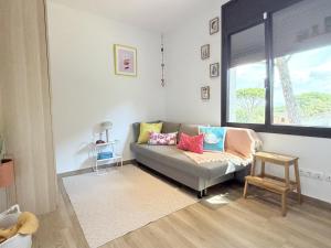 a living room with a couch and a window at Villa Pins by Costabravaway in Llagostera +30 photos