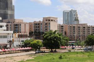 a city with tall buildings and a street with trees at Emerald hotel in Jomtien Beach