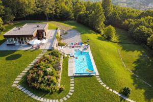 an aerial view of a house with a swimming pool at Villa Intelvi in Castiglione dʼIntelvi