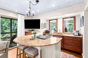 a kitchen with a center island with a tv at 3584 Shipwatch Rd in Kiawah Island