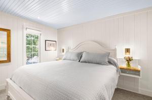 a white bedroom with a white bed and a window at 3584 Shipwatch Rd in Kiawah Island