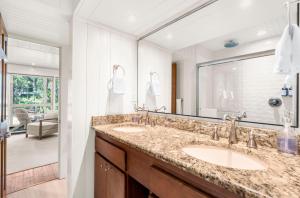 a bathroom with two sinks and a large mirror at 3584 Shipwatch Rd in Kiawah Island +18 photos