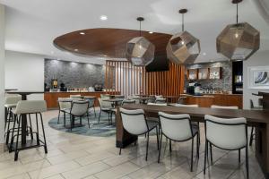 a restaurant with a bar and some stools at SpringHill Suites Dallas Arlington North in Arlington