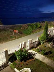 an empty road with a view of the ocean at Aether House Αιθήρ in Toroni