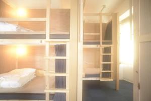a room with two bunk beds and a bed at Wharf Inn in Yokohama