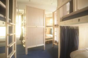 a dorm room with bunk beds and a bed at Wharf Inn in Yokohama +13 photos