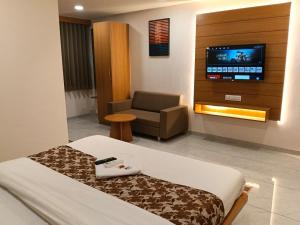 a hospital room with a bed and a tv at hotel vistara luxe in Himatnagar