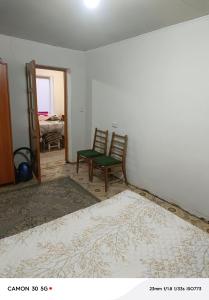an empty room with a bed and a chair at Сдается дача in Balqash