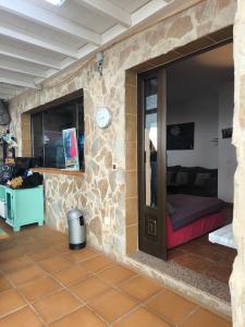 a room with a bed and a clock on a wall at LANZATE! in Tinajo
