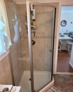 a shower with a glass door in a bathroom at Cozy Condo in Seaside Heights