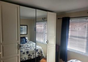 a room with a bedroom with a bed and a mirror at Cozy Condo in Seaside Heights