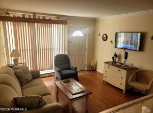 a living room with a couch and a chair and a table at Cozy Condo in Seaside Heights